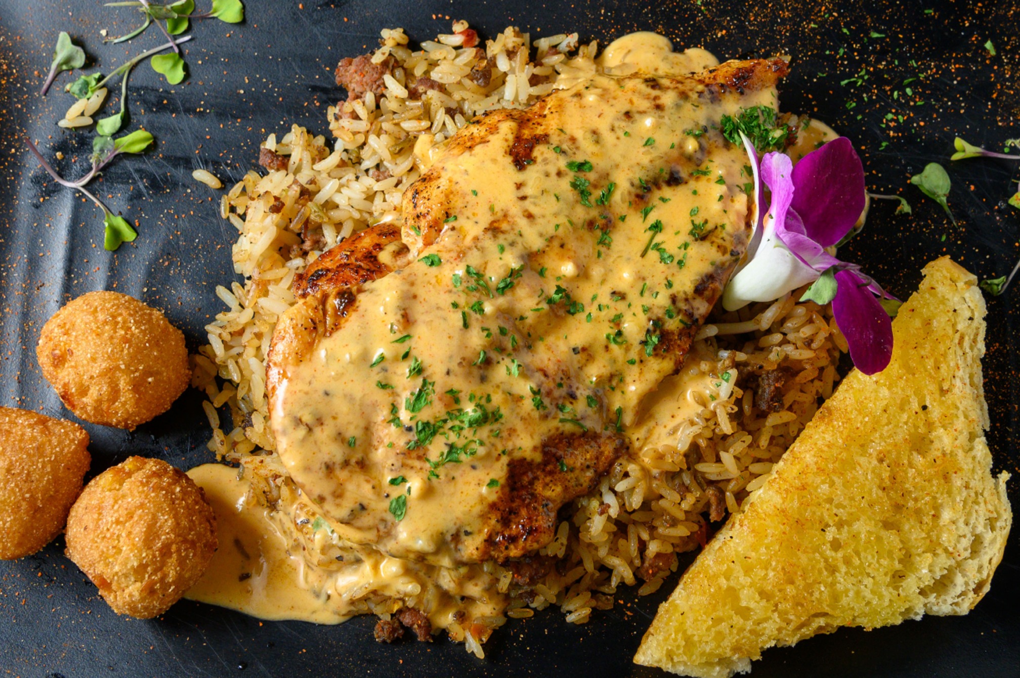 Gotti’s grilled chicken breast with dirty rice and hushpuppies