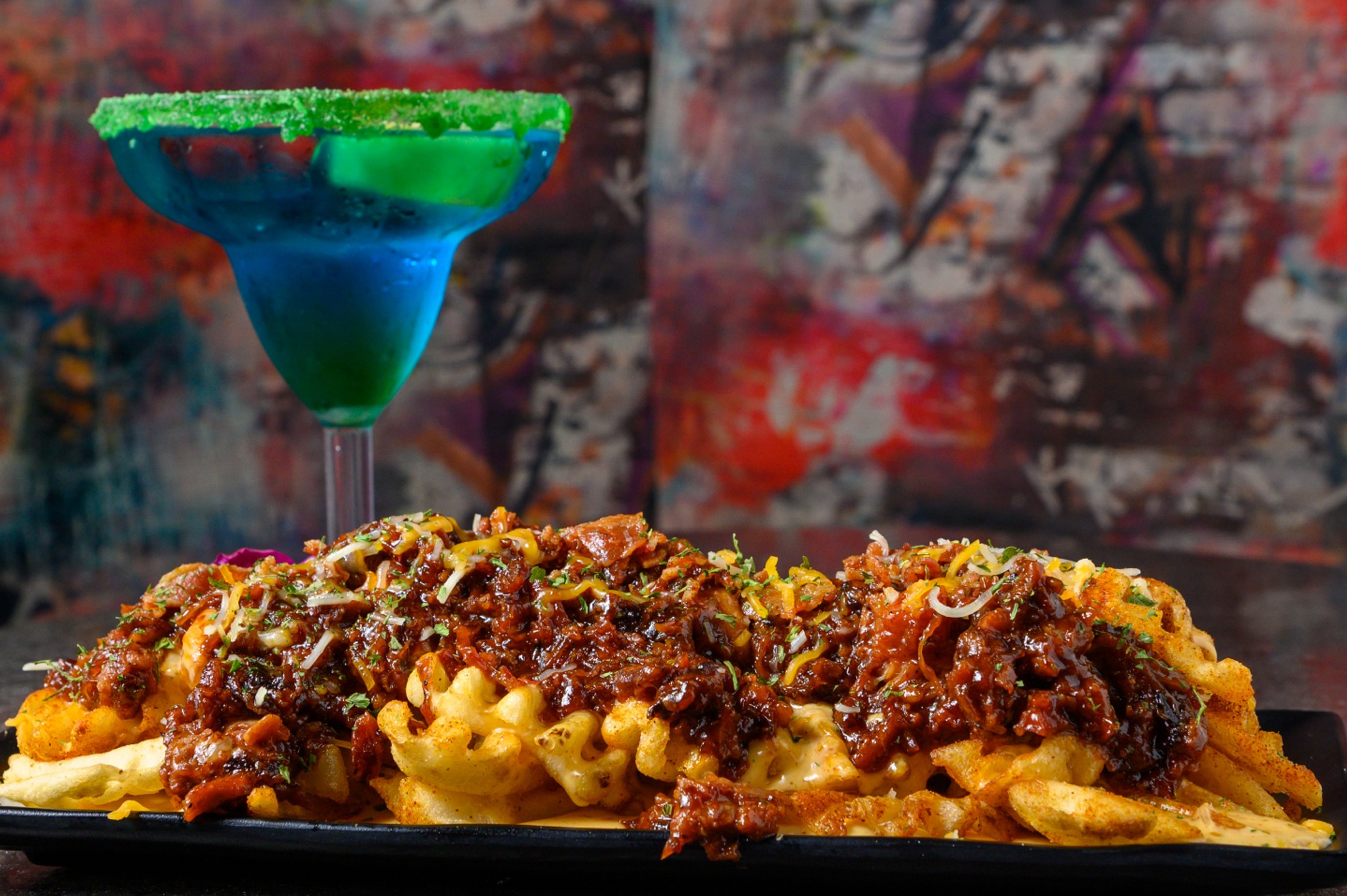 Gotti’s brisket fries with a cocktail