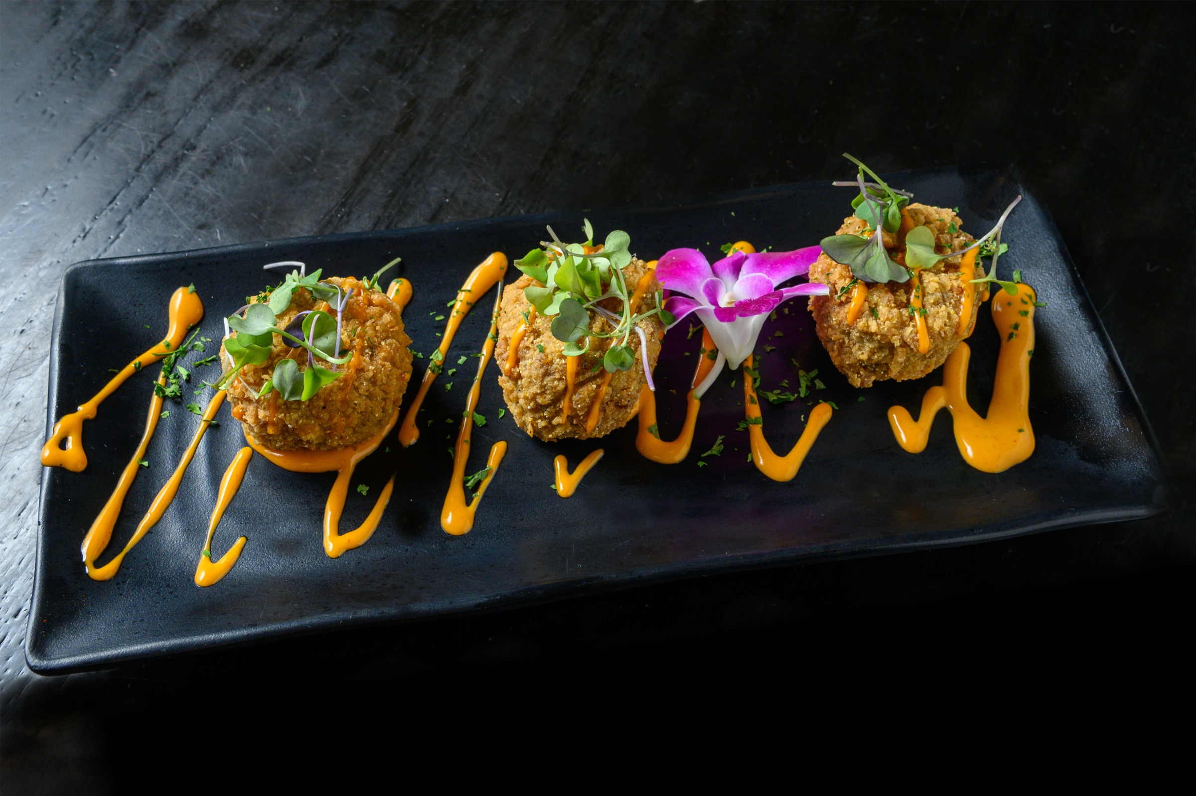 Gotti’s boudin balls with sauce and fresh garnish